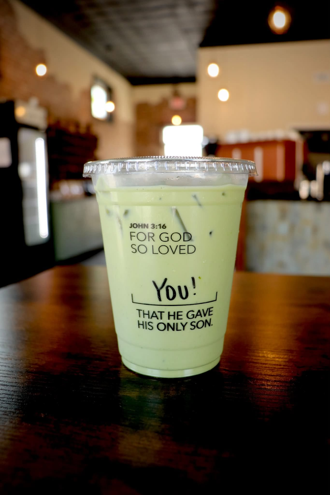 Iced drink in a clear cup on a cafe table